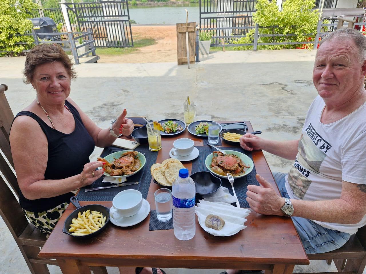 Couple Thumbs Up Dining Lagoon View