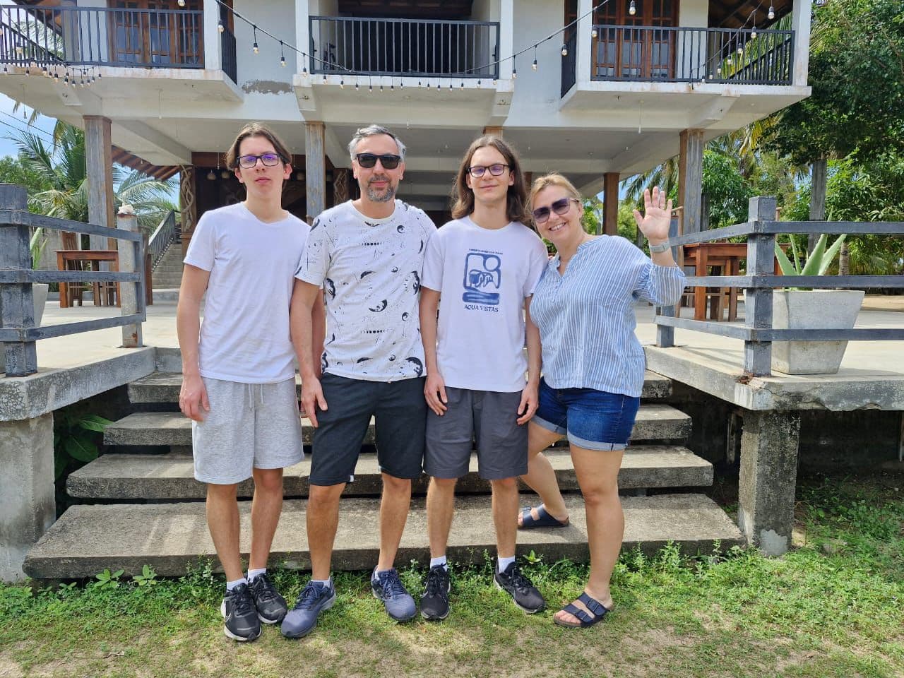 Family Four Guesthouse Steps Waving
