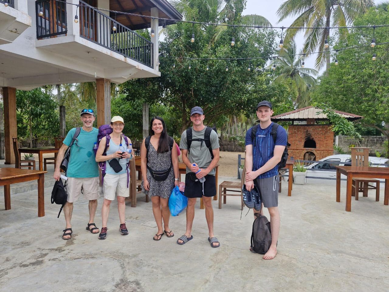 Five Backpackers Posing Restaurant Patio