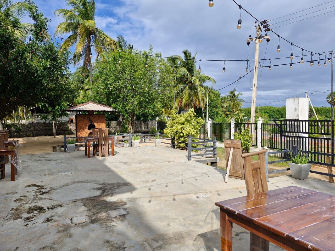 Outdoor terrace with chalkboard menu next to the brick oven