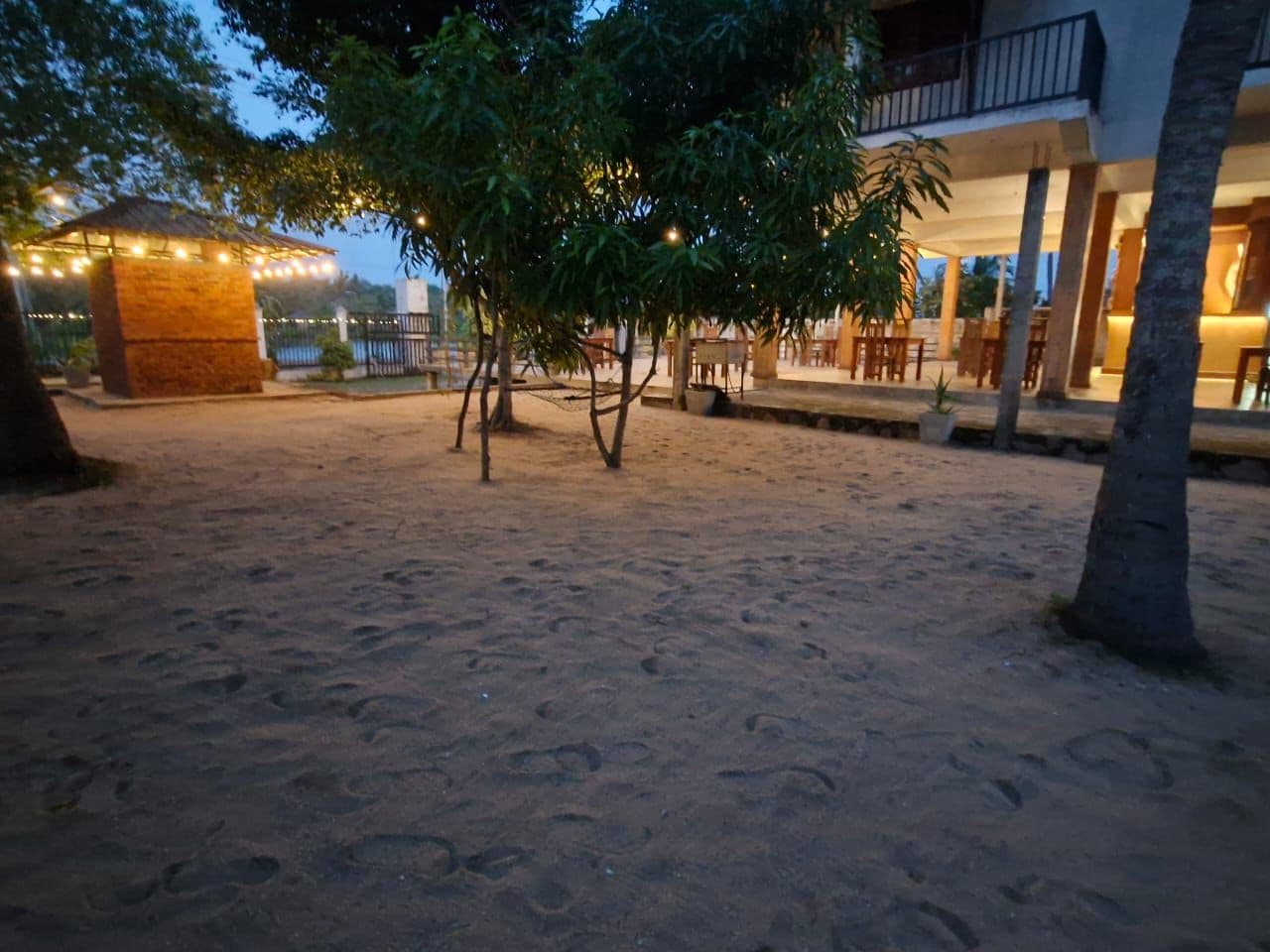 Resort grounds at dusk with the restaurant lit