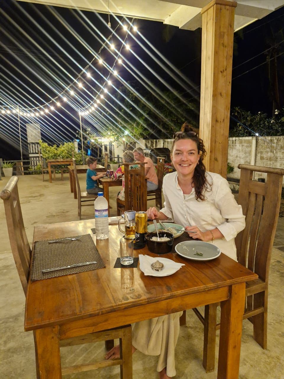 Romantic outdoor dinner under string lights
